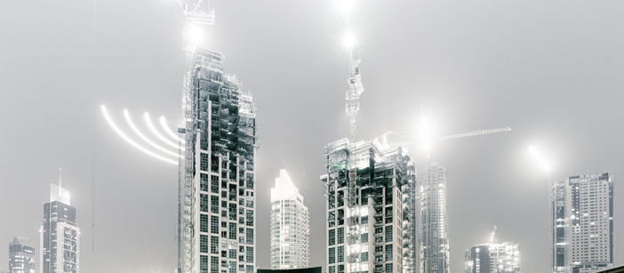 Skyscrapers and construction vehicles with different-looking lighting effects.